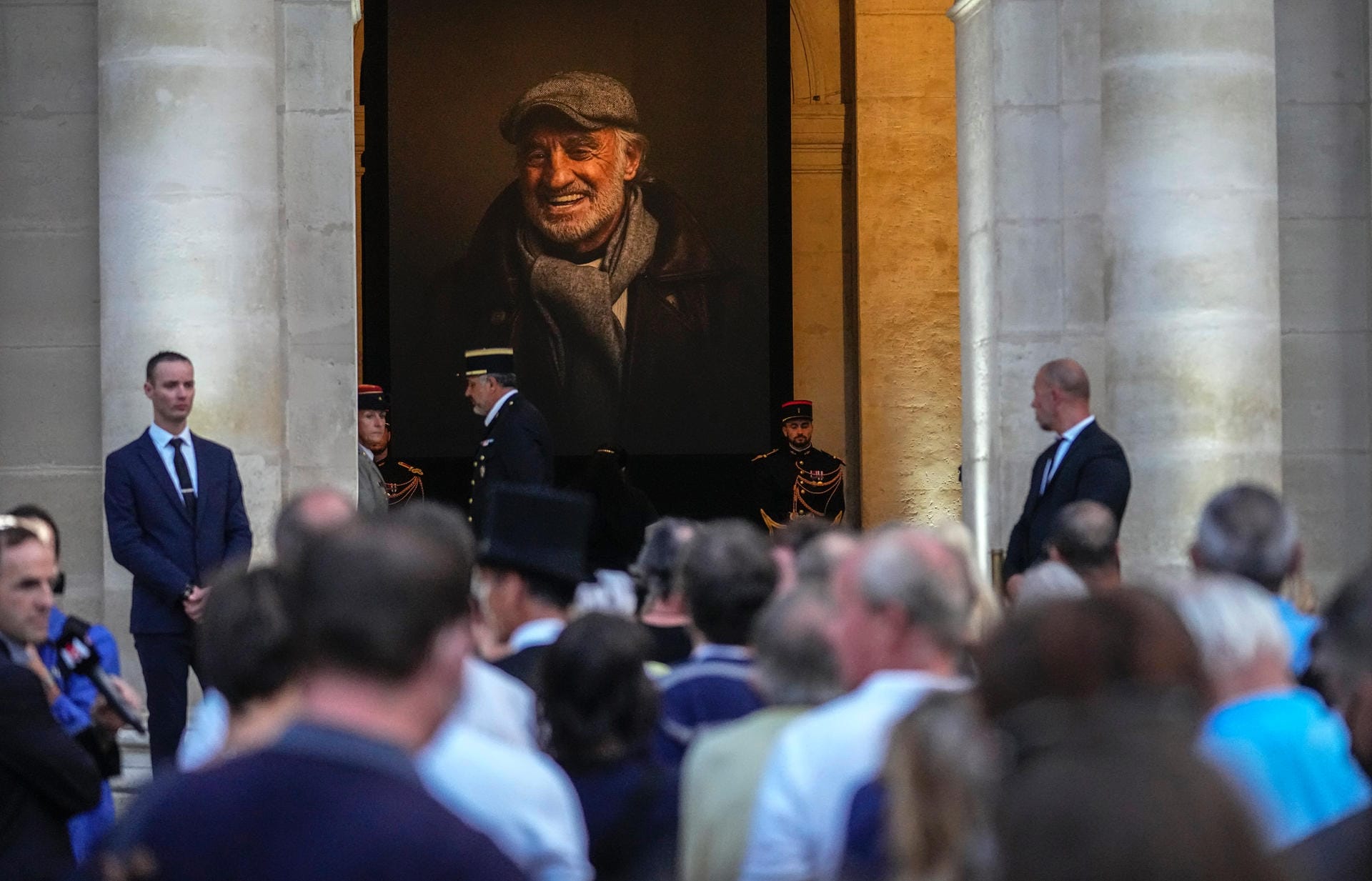 Menschen stehen an, um dem Sarg mit den sterblichen Überresten des französischen Schauspielers Jean-Paul Belmondo im Invalidendom zu sehen.