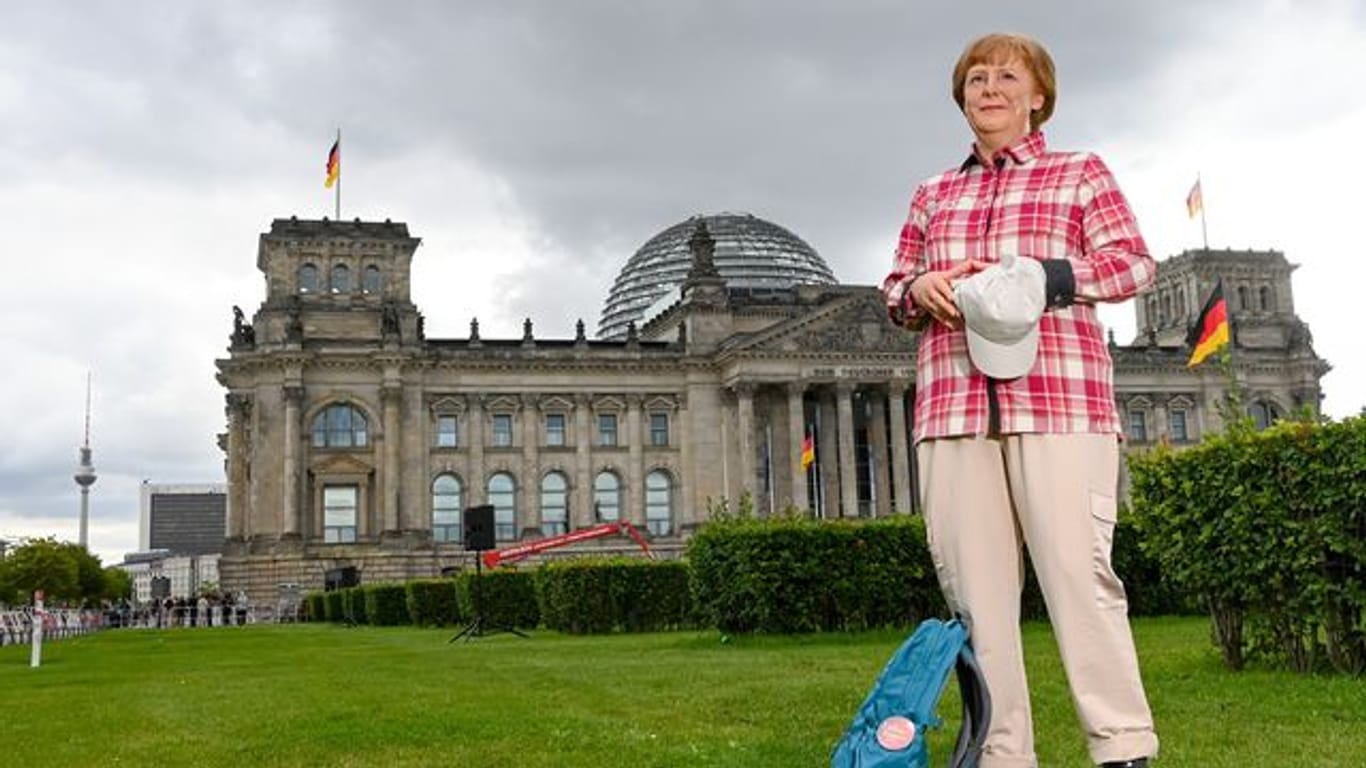 Die Wachsfigur von Bundeskanzlerin Angela Merkel (CDU) vor dem Reichstagsgebäude in Berlin.