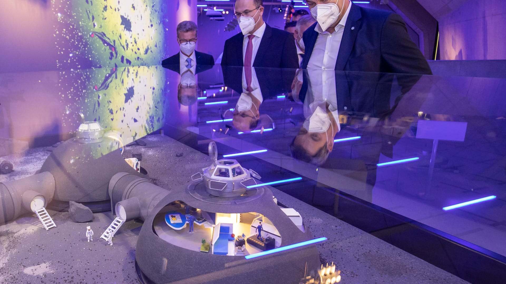 Markus Söder (r), CSU-Parteivorsitzender und Ministerpräsident von Bayern, betrachtet das Modell der Mondstation "Moon Village, die nach den Vorstellungen der NASA noch in diesem Jahrzehnt umgesetzt werden soll.
