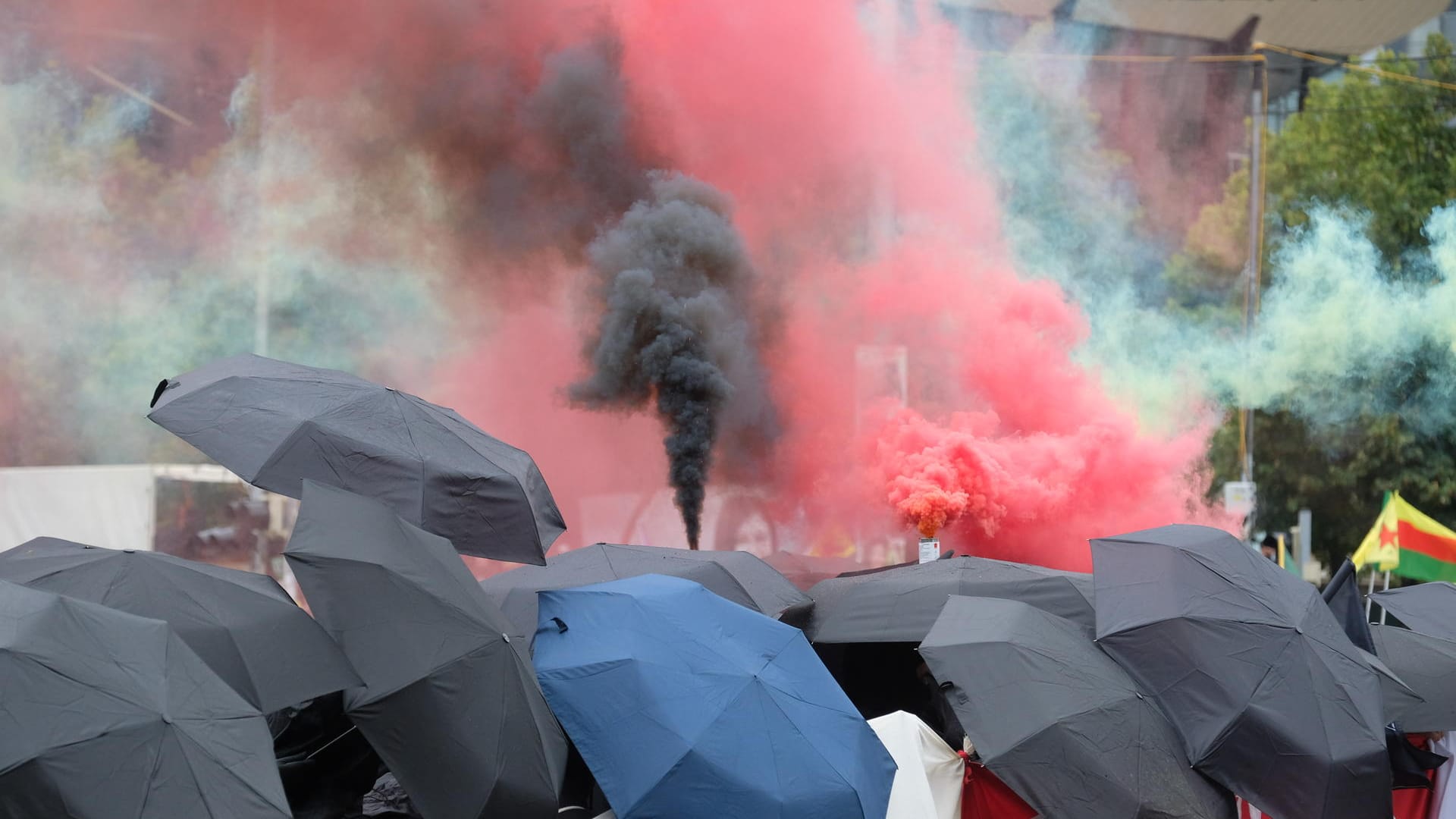 Teilnehmer einer Demonstration gehen eine Straße entlang: Es wurden Feuerwerkskörper gezündet.