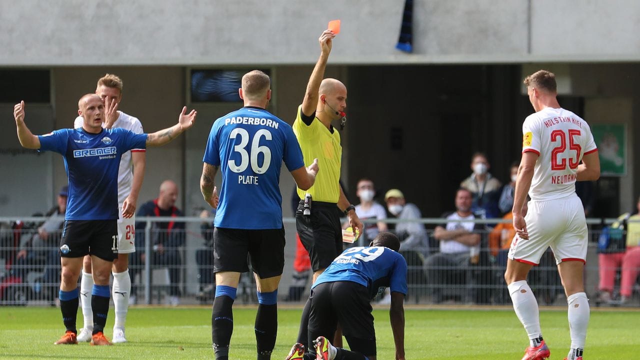 Schiedsrichter Franz Boskop (M) zeigt Paderborns Jamilu Collins (2.