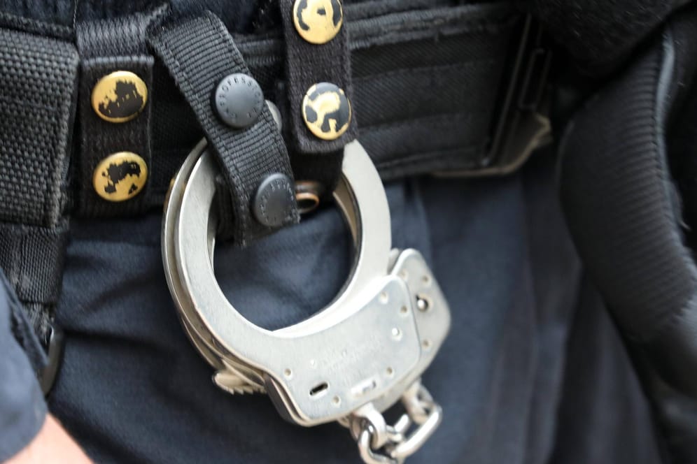 Ein Polizist trägt Handschellen am Gürtel (Symbolbild): In Berlin wurde ein Mann festgenommen, der in die Luft geschossen haben soll.