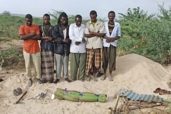 Somali men from southern Somalia offer funeral prayers for a dead child in...