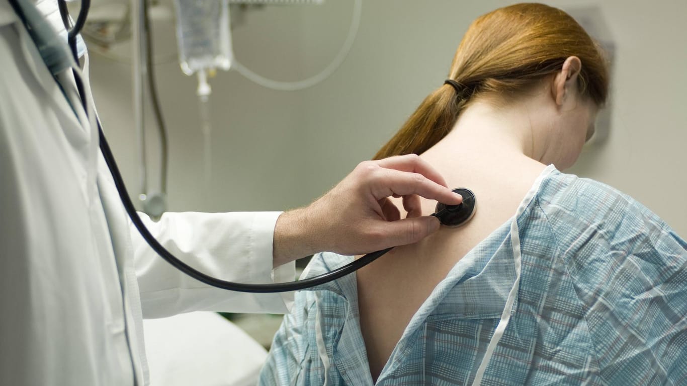 Arzt untersucht Patientin: Rasselgeräusche beim Einatmen können ein Anzeichen für eine Fibrose sein.