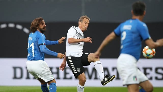 Jürgen Klinsmann (M) trift zum 2:0 für die DFB-All-Star, Italiens Andrea Pirlo (l) kommt zu spät. Jürgen Klinsmann (M) trift zum 2:0 für die DFB-All-Star, Italiens Andrea Pirlo (l) kommt zu spät.