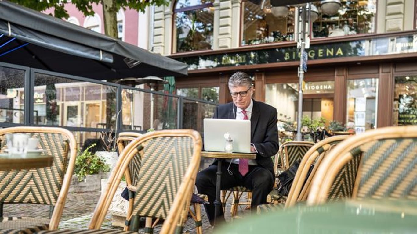 Der Investment-Banker Thorsten Müller bereitet sich in einem Cafe in der Bankenmetropole Frankfurt am Main auf eine Video-Konferenz vor.