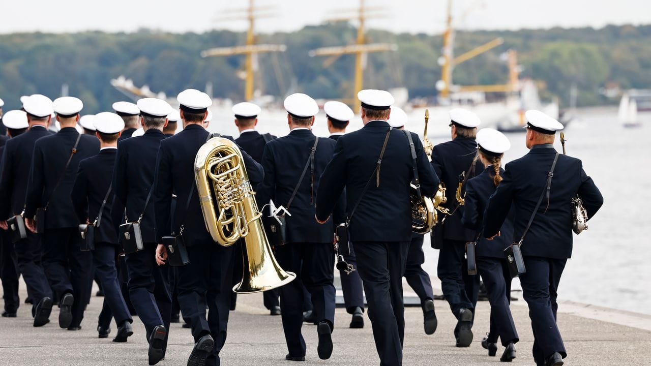 Orchester-Mitglieder der Bundeswehr gehen vor dem Eintreffen der "Gorch Fock" am Hafen entlang. Orchester-Mitglieder der Bundeswehr gehen vor dem Eintreffen der "Gorch Fock" am Hafen entlang.