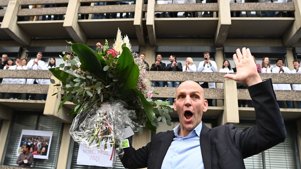 Benjamin List freut sich mit einem Blumenstrauß bei der Ankunft am Max-Planck-Institut (MPI) für Kohlenforschung.