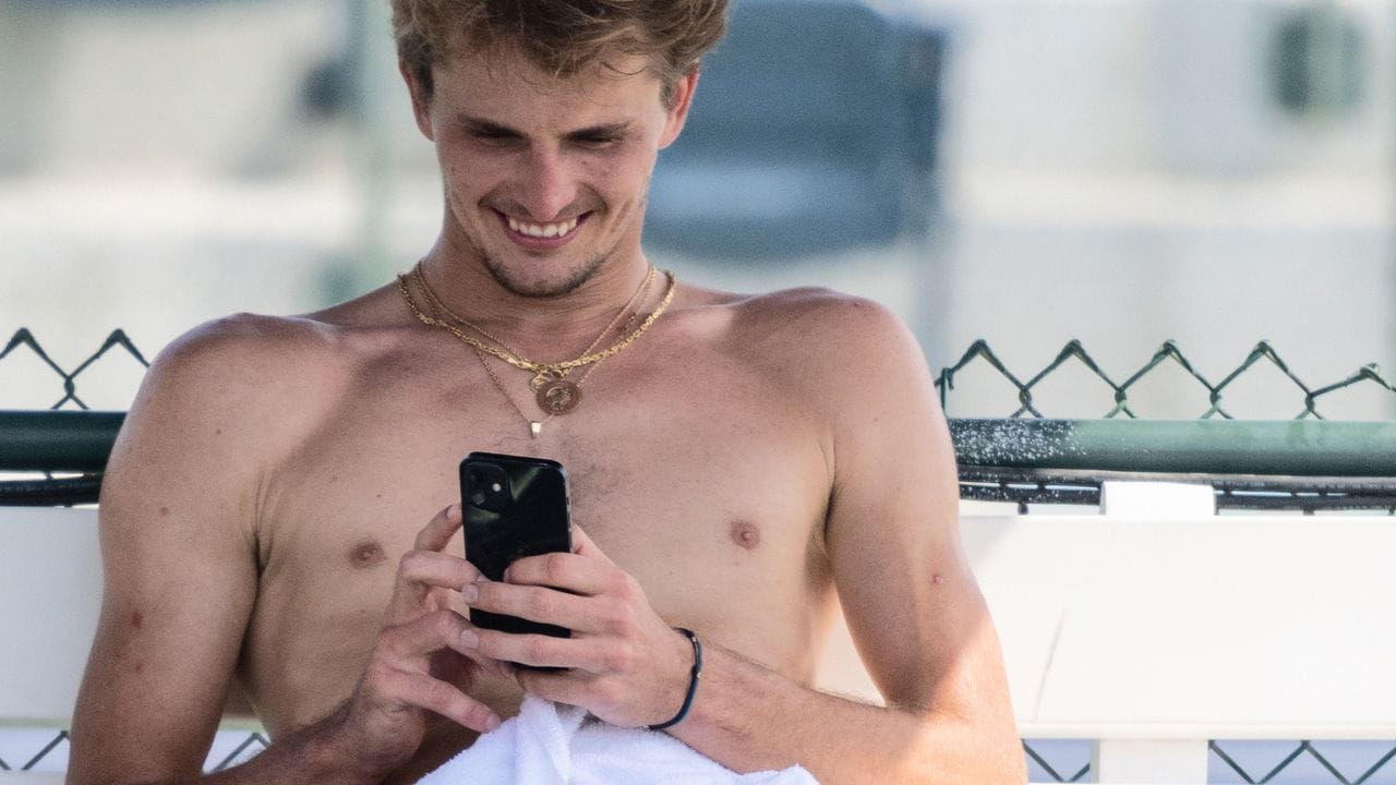 Da lächelt Tennisprofi Alexander Zverev beim Blick aufs Handy: Liest er vielleicht eine Nachricht von Sophia Thomalla?. Da lächelt Tennisprofi Alexander Zverev beim Blick aufs Handy: Liest er vielleicht eine Nachricht von Sophia Thomalla?.