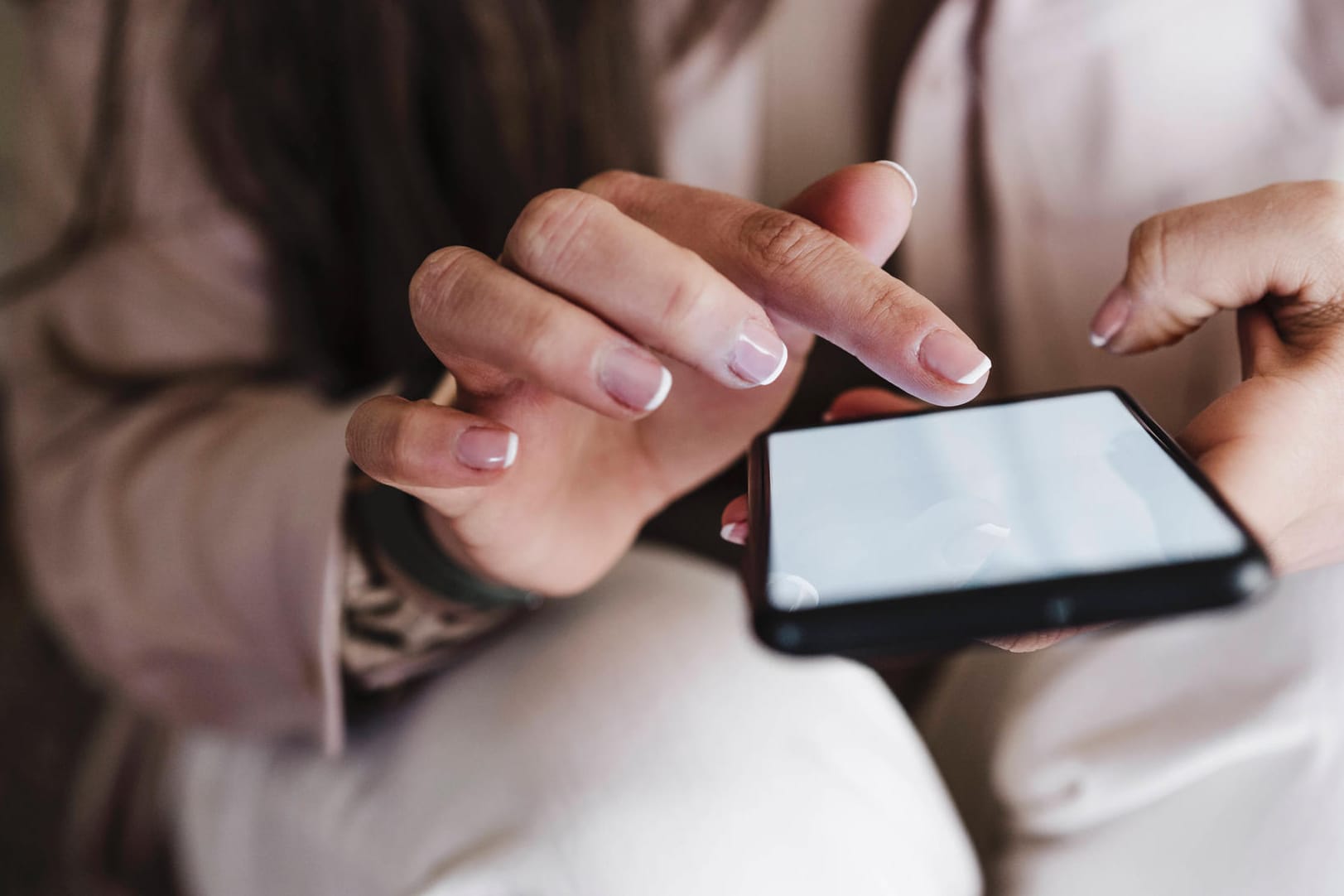 Hands of woman using smart phone at home model released Symbolfoto property released EBBF02914