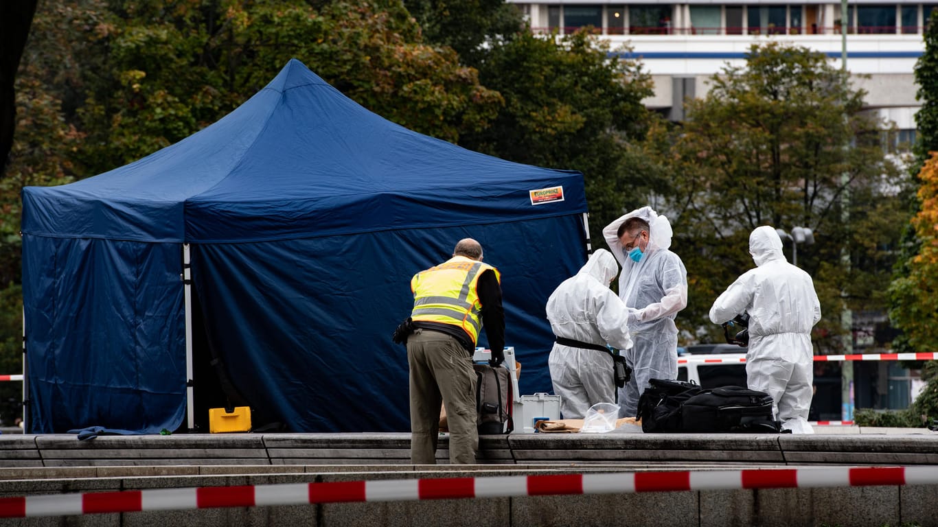Kriminaltechniker stehen am Alexanderplatz unterhalb des Fernsehturms neben einem Zelt: Dort wurde die Leiche gefunden.