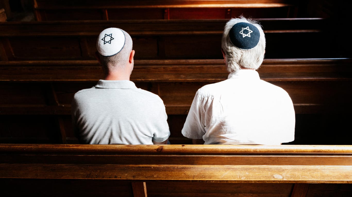 Zwei Männer sitzen in einer Synagoge: Deutschland diskutiert erneut über Antisemitismus.