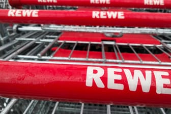 Rewe-Einkaufswagen (Symbolbild): Gegen eine Metzgerei, die das Handelsunternehmen beliefert, gibt es Hygiene-Vorwürfe.