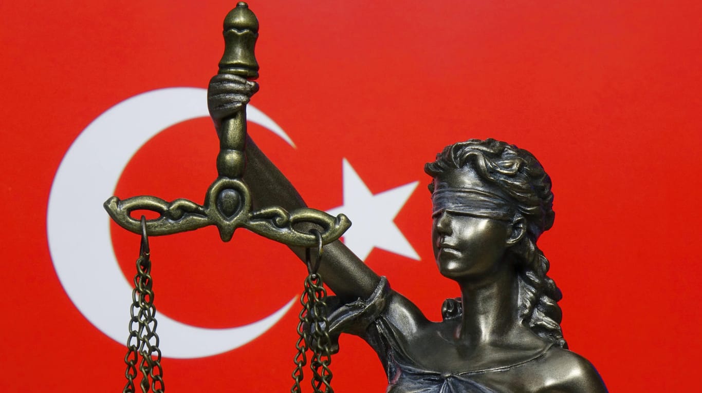 Die Justitia vor dem Hintergrund der Nationalflagge der Türkei (Symbolbild): In der Türkei hat ein Gericht einen Deutschen wegen "Terrorpropaganda" verurteilt.