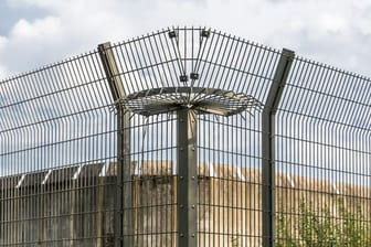 Eine Mauer und ein Drahtzaun eines Gefängnisses