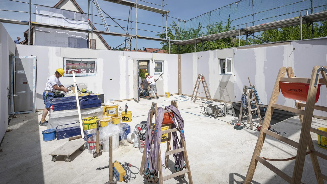 Handwerker bauen ein Haus (Symbolbild): Kommen auf der Baustelle Menschen zu Schaden, springt die Bauherrenhaftpflichtversicherung ein.