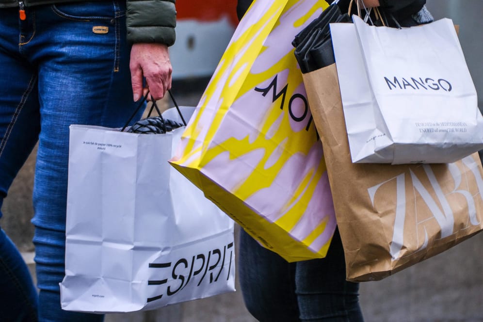 Menschen mit Einkaufstüten (Symbolbild): Viele Verbraucher kaufen derzeit mehr ein.