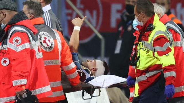 Der Nürnberger Tom Krauß (M) wird verletzt aus dem Stadion getragen, zeigt aber mit dem Daumen nach oben. Der Nürnberger Tom Krauß (M) wird verletzt aus dem Stadion getragen, zeigt aber mit dem Daumen nach oben.
