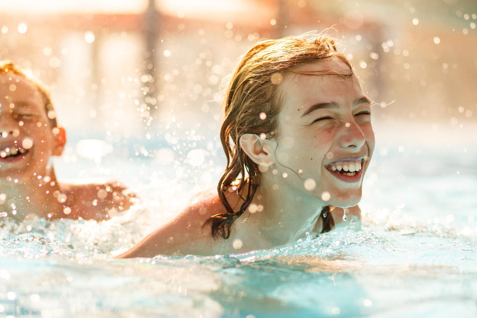 Kinder planschen im Pool: Gerötete Augen und gereizte Schleimhäute können Hinweise auf eine Chlorreizung sein.