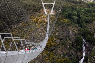 People walk on the world's longest pedestrian suspension bridge '516 Arouca', in Arouca