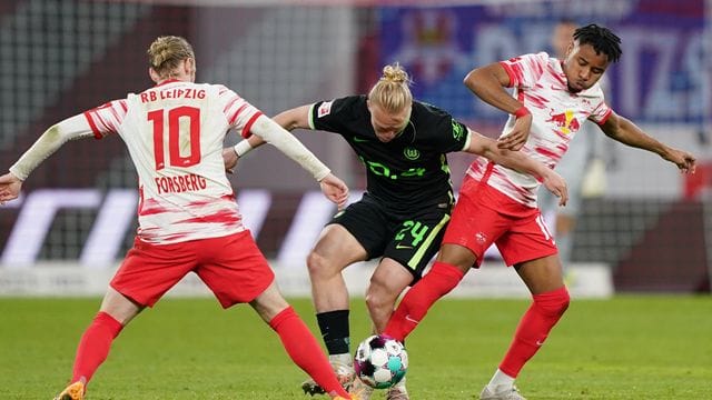 Wolfsburgs Xaver Schlager (M) im Zweikampf mit den Leipzigern Christopher Nkunku (r) und Emil Forsberg. Wolfsburgs Xaver Schlager (M) im Zweikampf mit den Leipzigern Christopher Nkunku (r) und Emil Forsberg.