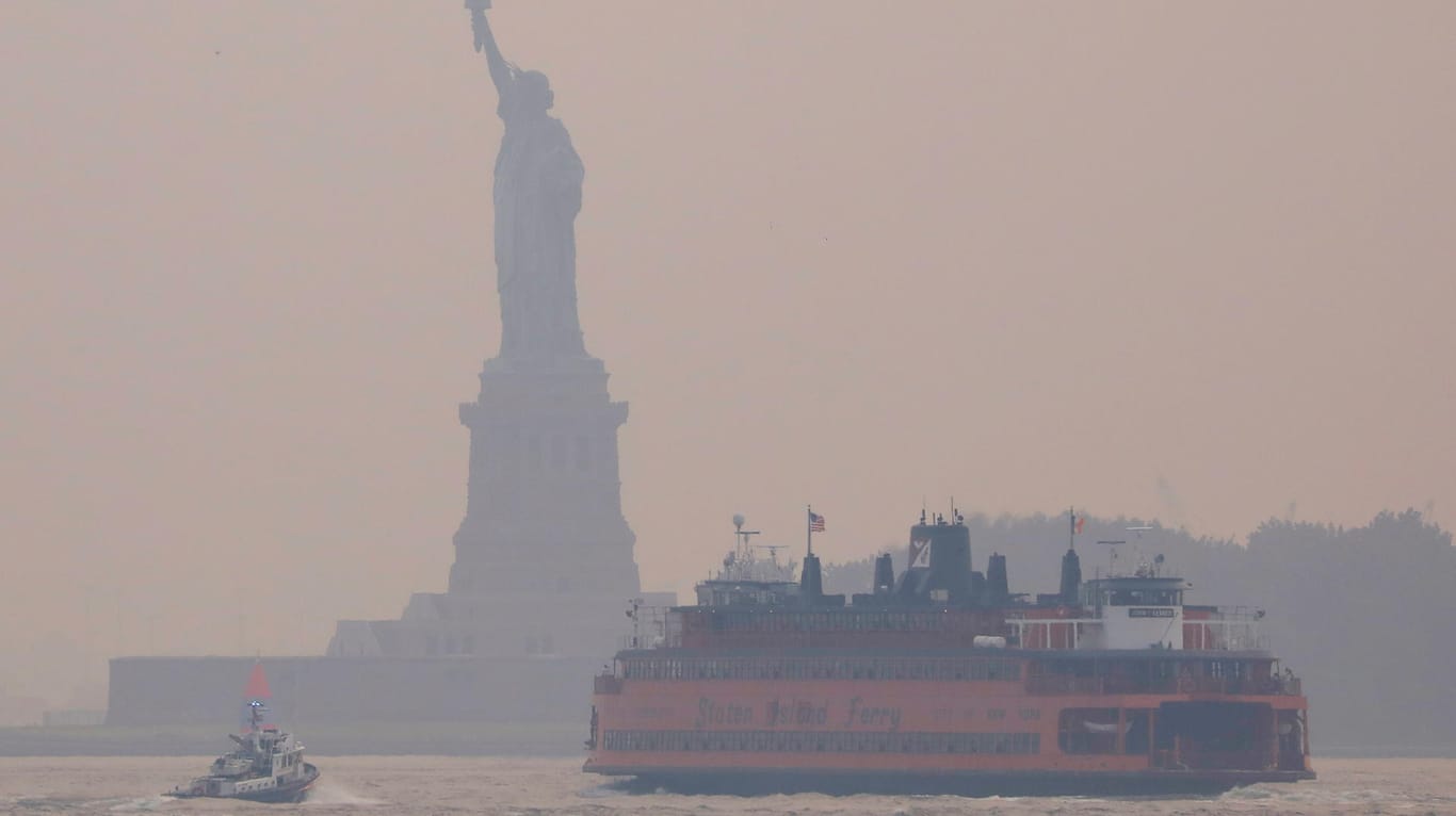 Statue of Liberty seen through cover of wildfire smoke in New York City