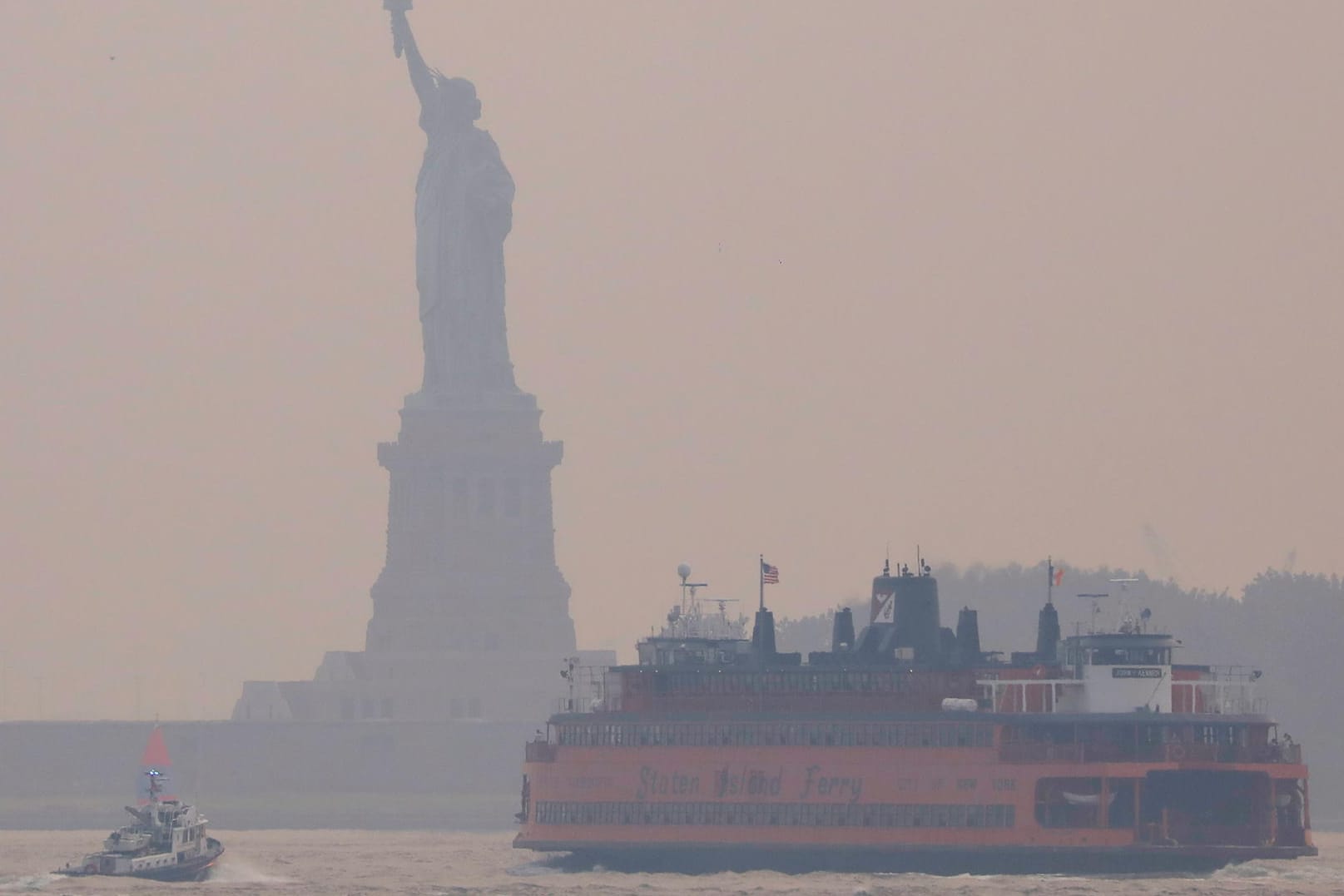 Statue of Liberty seen through cover of wildfire smoke in New York City