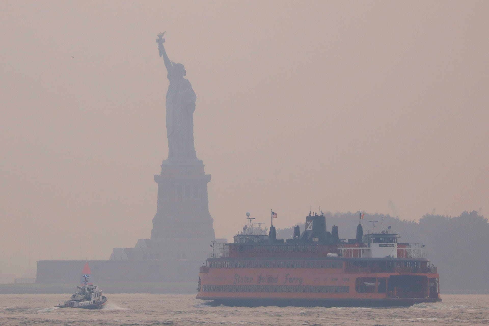 Statue of Liberty seen through cover of wildfire smoke in New York City