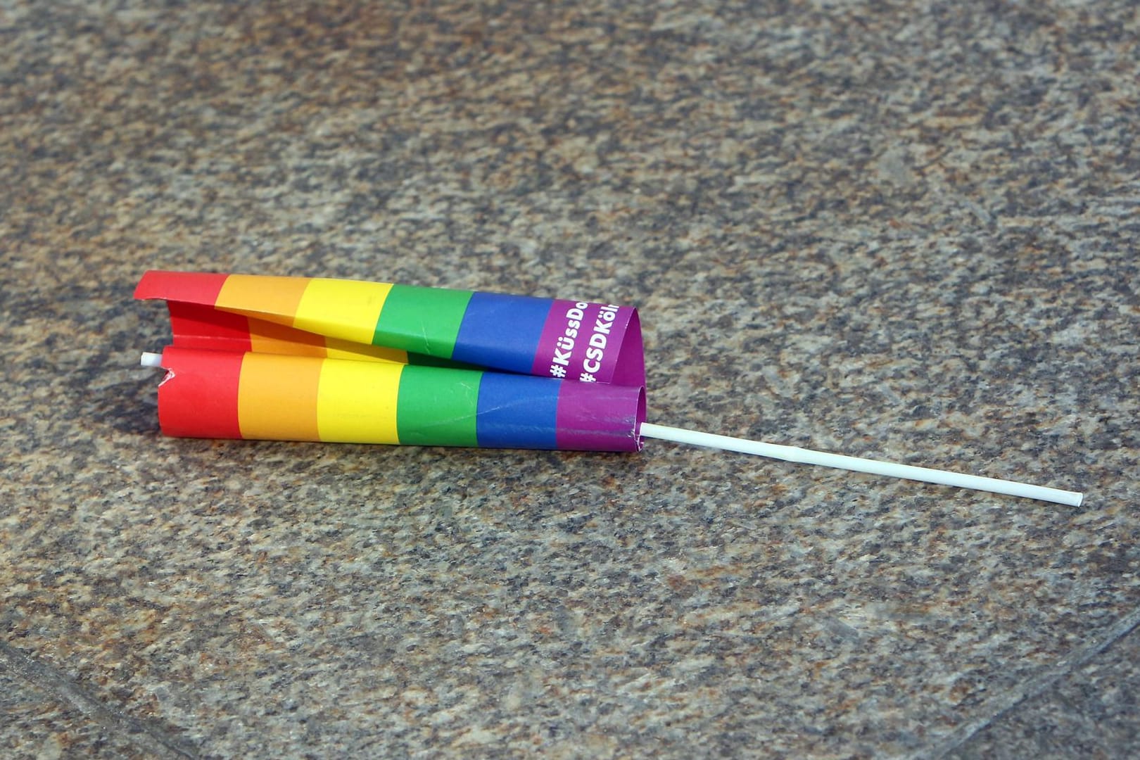 Eine Regenbogenflagge liegt verlassen auf dem Boden der Domplatte in Köln (Archivbild): Die Angriffe auf queere Menschen haben zugenommen.