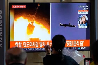 Menschen im im Seouler Bahnhof sehen während einer Nachrichtensendung ein Fernsehbild des nordkoreanischen Raketenstarts.