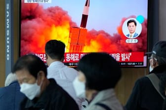 Menschen im im Seouler Bahnhof sehen während einer Nachrichtensendung ein Fernsehbild des nordkoreanischen Raketenstarts.
