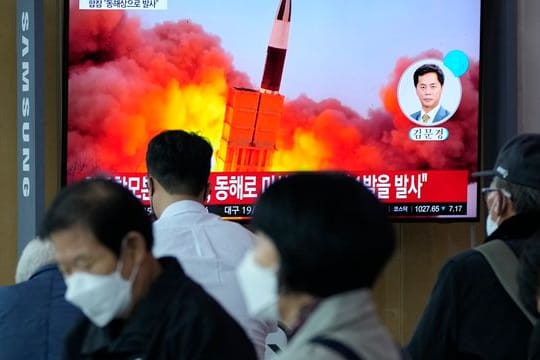 Menschen im im Seouler Bahnhof sehen während einer Nachrichtensendung ein Fernsehbild des nordkoreanischen Raketenstarts.