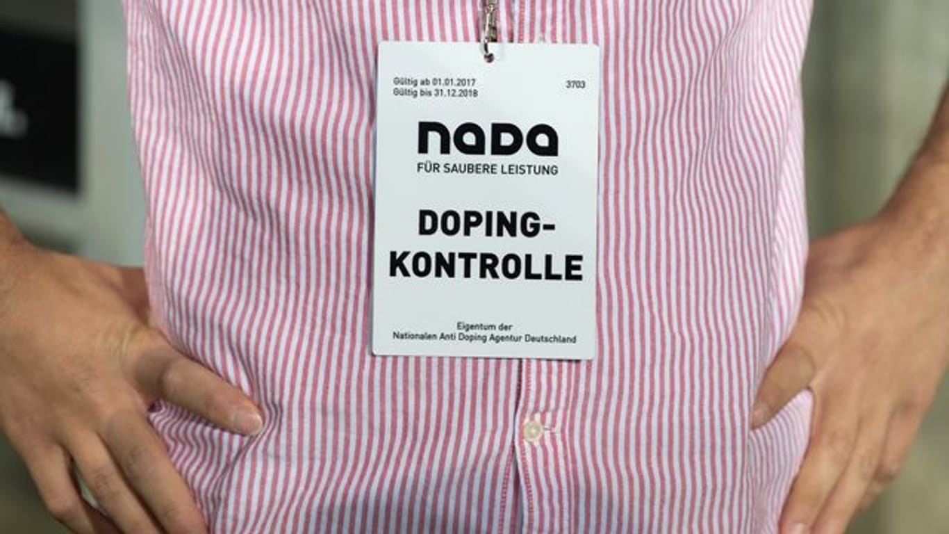 Ein Mitarbeiter der Nationalen Anti Doping Agentur (NADA) trägt einen Ausweis mit der Aufschrift "Dopingkontrolle" um den Hals.