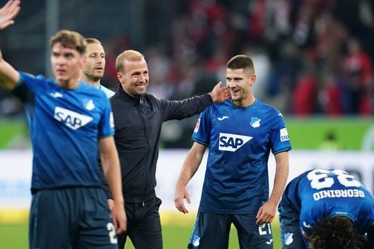 Hoffenheims Robert Skov, Trainer Sebastian Hoeneß, Benjamin Hübner und Georginio Rutter (l-r) feiern nach der Partie.