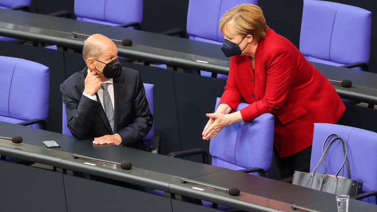 Olaf Scholz und Angela Merkel auf der Regierungsbank im Bundestag: Noch nicht ganz da, und noch nicht so richtig weg.