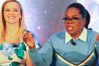 Reese Witherspoon (l.) und Oprah Winfrey bei einer Pressekonferenz (Archivbild): Die beiden Stars haben in das Unterwäschelabel Spanx investiert.