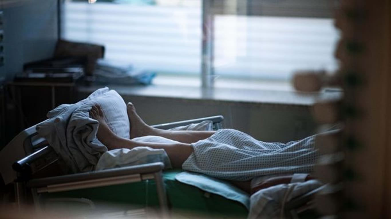 Ein Patient liegt in einem Zimmer auf einer Corona-Intensivstation.