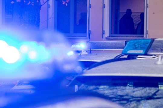 Polizeifahrzeuge stehen mit Blaulicht