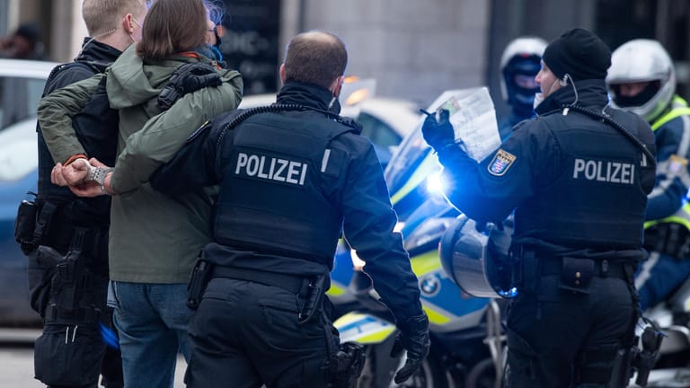 Polizisten nehmen in Frankfurt eine Teilnehmerin einer Demonstration gegen die derzeit geltenden Corona-Maßnahmen fest: Auch in Bremen war die Polizei am Wochenende gefordert.