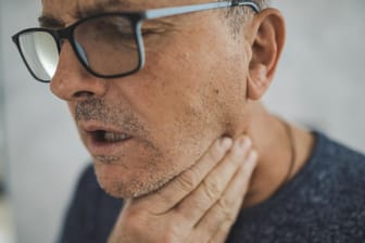Halsschmerzen: Sie zählen zu den ersten Anzeichen einer Corona-Infektion. Laut einer Studie lassen die Beschwerden oftmals mit der richtigen Ernährung mildern.