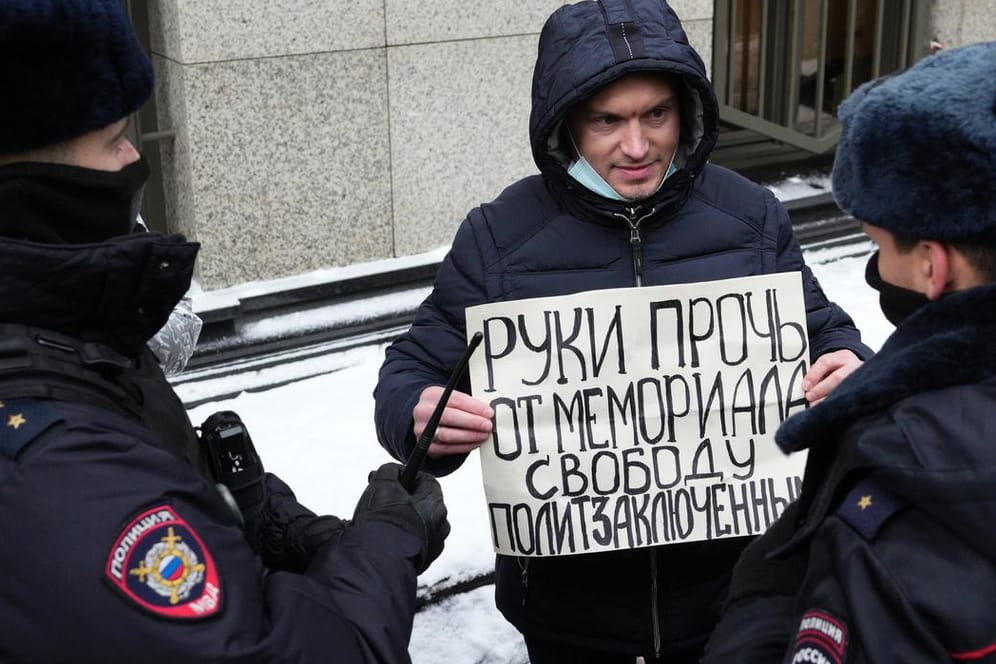 Polizisten halten einen Demonstranten vor dem Obersten Gerichtshof in Moskau fest: Er fordert "Hände weg von Memorial, Freiheit für politische Gefangene".