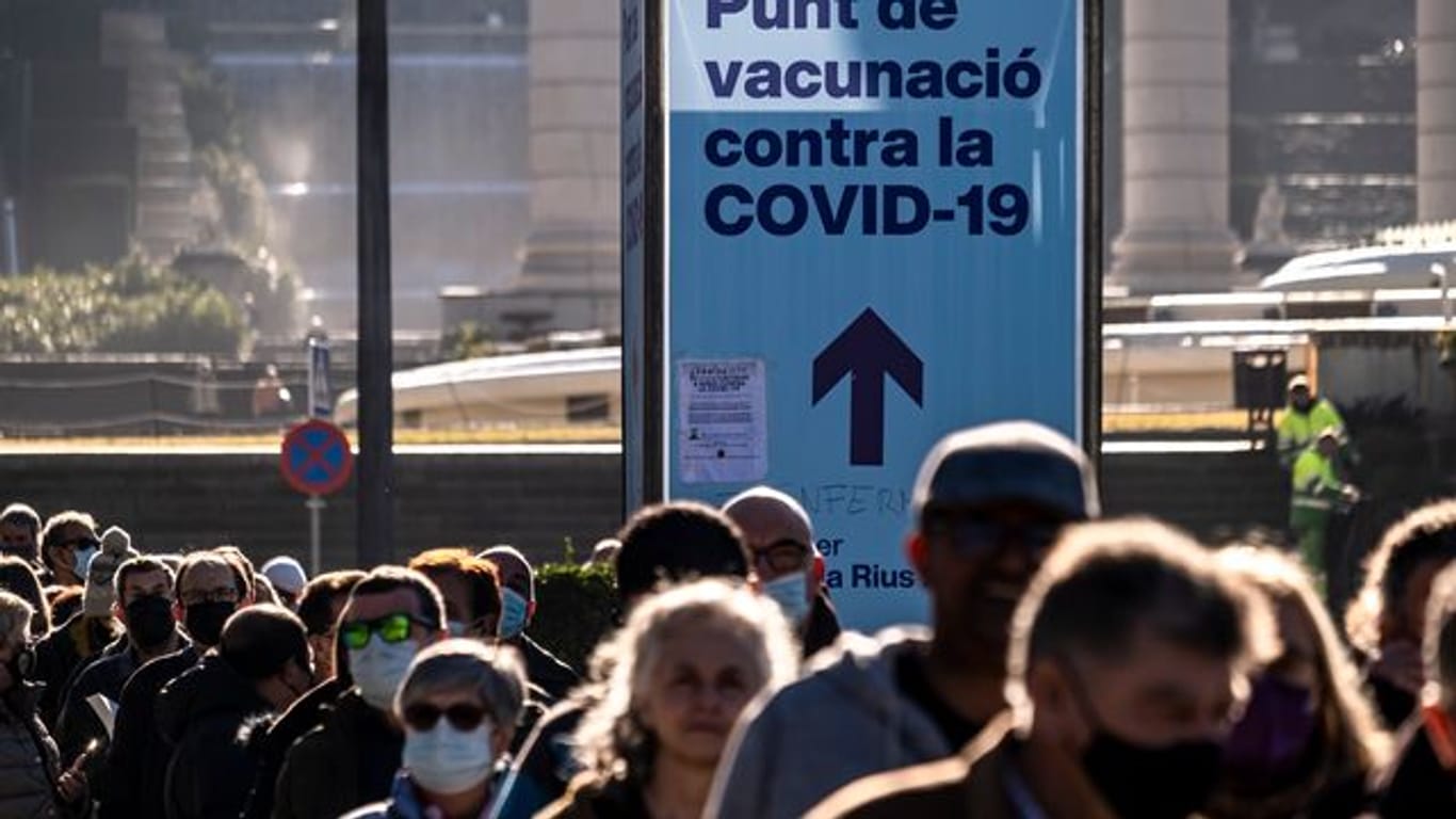 Zahlreiche Menschen stehen in Barcelona Schlage vor einer Impfstelle.