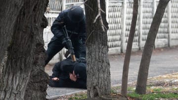 Ein Polizist drückt einen Mann in Almaty zu Boden: Die Lage soll sich beruhigt haben, teilt Kasachstans Regierung am Wochenende mit. Laut anderen Quellen halten die Kämpfe an.