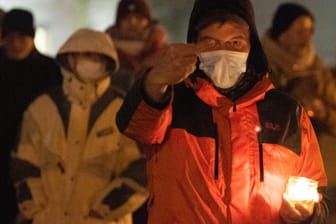 Gegenprotest mit Maske, Kerze und Stinkefinger: Wie hier in Dresden protestieren auch in anderen Städten immer mehr Menschen gegen Corona-"Spaziergänge".