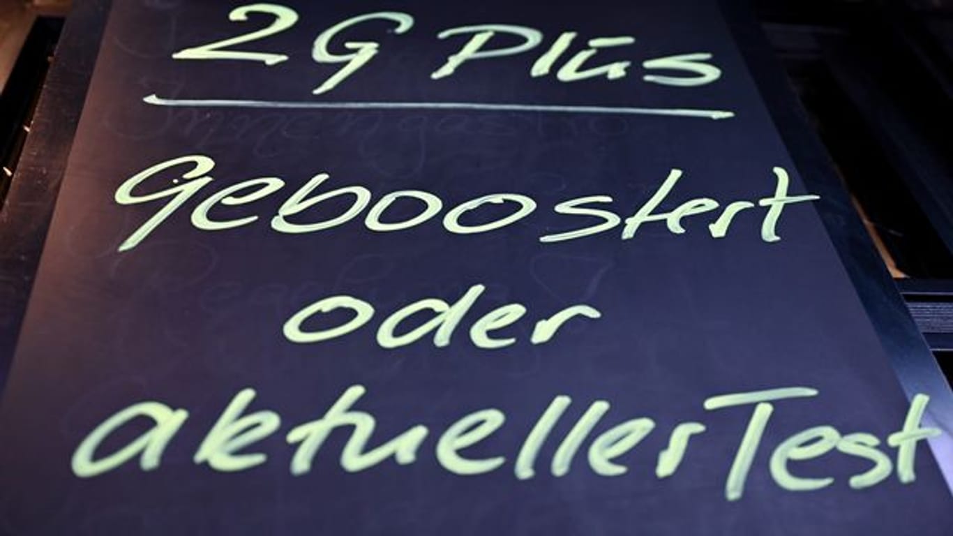 Am Eingang einer Kneipe hängt ein Hinweis mit der Aufschrift "2G Plus - geboostert oder aktueller Test": Ab sofort gelten in Nordrhein-Westfalen neue Corona-Regeln.