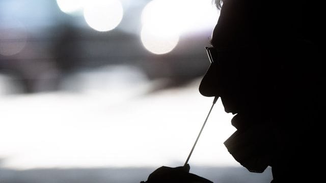 Ein medizinischer Mitarbeiter entnimmt einem Mann einen Nasenabstrich für einen Corona-Schnelltest (Symbolbild): Unter anderem geboosterte Kontaktpersonen müssen künftig nicht mehr in Quarantäne. Ein medizinischer Mitarbeiter entnimmt einem Mann einen Nasenabstrich für einen Corona-Schnelltest (Symbolbild): Unter anderem geboosterte Kontaktpersonen müssen künftig nicht mehr in Quarantäne.