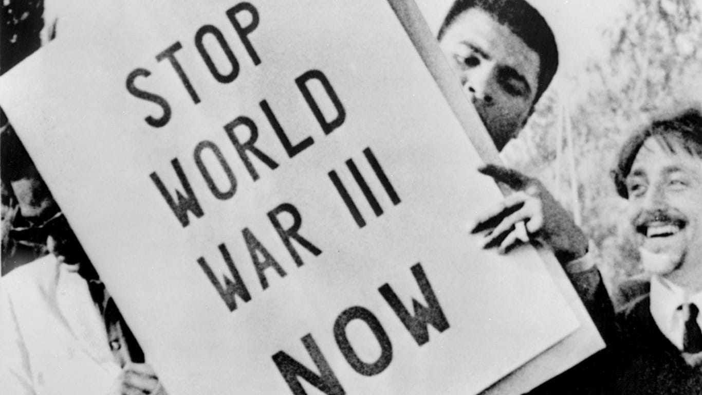 Ali hinter einem Anti-Kriegs-Plakat 1967: Wegen seiner Ablehnung des Vietnamkriegs und Wehrdienstverweigerung wurde der damalige Schwergewichtschamp für drei Jahre gesperrt.