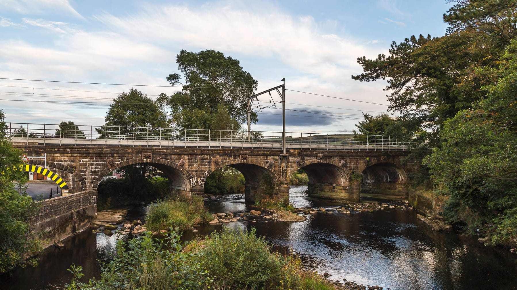 Brücke über einem Fluss in England (Symbol): Elf Menschen waren in einem Fahrzeug mit Anhänger unterwegs, als eine Brücke einstürzte.