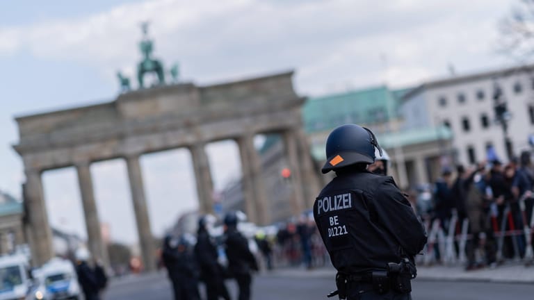 Ein Polizist bei einem Einsatz am Brandenburger Tor (Archivbild): Omikron stellt auch die Beamten vor Herausforderungen.