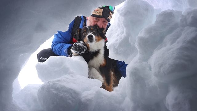 Der Hundeführer Dörg Stephan sucht mit seiner Lawinensuchhündin Amira nach einem Verschütteten. Der Hundeführer Dörg Stephan sucht mit seiner Lawinensuchhündin Amira nach einem Verschütteten.
